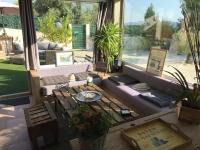 a living room with a couch and a table at La Maison des Délices in Le Beausset