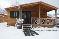 a log cabin with a porch in the snow at Chalet Hertzland in Ranspach