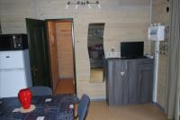 a room with a kitchen with a table and a television at Chalet Hertzland in Ranspach