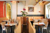 a restaurant with tables and chairs and a vase of flowers at The Pucic Palace in Dubrovnik