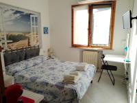 Postel nebo postele na pokoji v ubytování La Casa di Berenice a Porto Azzurro
