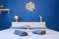 a blue bedroom with a bed with blue walls and pillows at L&#39;Escale - 2 Chambres balcon à 5 min des plages in Marseille