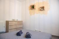 a bedroom with a bed with two pairs of shoes on it at L&#39;Escale - 2 Chambres balcon à 5 min des plages in Marseille