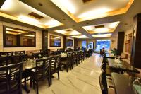 a dining room with tables and chairs in a restaurant at Tekareesinn in Lucknow
