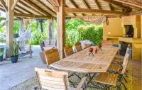 a wooden table and chairs on a patio at Beautiful Home In Fleurac With 3 Bedrooms, Private Swimming Pool And Outdoor Swimming Pool in Fleurac