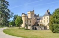 a castle on a grassy field in front of a building at Beautiful Home In Fleurac With 3 Bedrooms, Private Swimming Pool And Outdoor Swimming Pool in Fleurac
