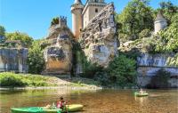 people kayaking on the river in front of a castle at Beautiful Home In Fleurac With 3 Bedrooms, Private Swimming Pool And Outdoor Swimming Pool in Fleurac