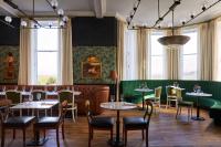 a restaurant with tables and chairs and windows at Marine North Berwick in North Berwick