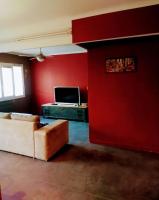 a living room with a red wall and a couch at Le Passe-Port pour Marseille in Marseille