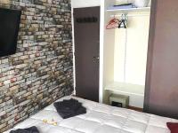a bedroom with a brick wall and a bed at Le Passe-Port pour Marseille in Marseille