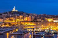 a group of boats docked in a harbor at night at Le Passe-Port pour Marseille in Marseille