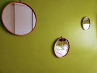 two mirrors on a green wall in a bedroom at Le Passe-Port pour Marseille in Marseille