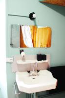 a bathroom with a white sink and a mirror at Eau Berges in Vicdessos