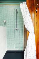 a shower curtain is hanging in a bathroom at Eau Berges in Vicdessos