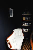 a white chair in a room with a book shelf at Eau Berges in Vicdessos