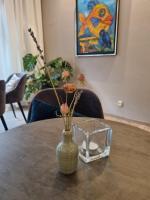 a vase with flowers in it sitting on a table at Hotel Diamant in Wedel