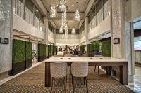 a large lobby with a large table and chairs at Holiday Inn Toronto Downtown Centre by IHG in Toronto