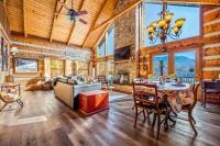 ein Wohnzimmer mit Tisch und Stühlen und einem Kamin in der Unterkunft Barenberg Cabin - Secluded Unobstructed Panoramic Smoky Mountains View with Two Master Suites, Loft Game Room, and Hot Tub in Gatlinburg