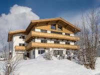 a large building with snow in front of it at Haus Seisl in Söll