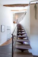 a staircase in a house with wooden floors and white walls at Monte Arena Chambre d&#39;hôtes in Montaren-et-Saint-Médiers