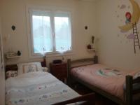 two twin beds in a room with a window at les petites roches in Saint-Fortunat-sur-Eyrieux