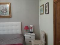 a bedroom with a bed and a chair and a nightstand at les petites roches in Saint-Fortunat-sur-Eyrieux