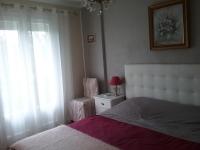 a bedroom with a bed and a window at les petites roches in Saint-Fortunat-sur-Eyrieux