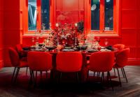a red dining room with a table and red chairs at Naumi Hotel Wellington in Wellington