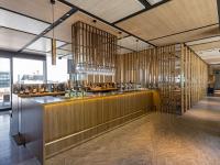 a bar in a restaurant with wooden dividers at THE BLOSSOM KUMAMOTO in Kumamoto