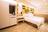 a hotel room with two beds and a kitchen at Ximen Citizen Hotel in Taipei