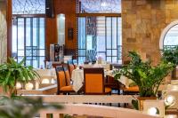a dining room with tables and chairs and windows at Crowne Plaza Foshan by IHG in Foshan