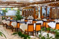 a dining room with white tables and chairs at Crowne Plaza Foshan by IHG in Foshan