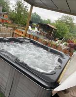 a large hot tub with water in a backyard at Gite wellness Au champ du bouillon proche de Pairi Daiza et de la ville Ath 