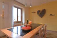 a dining room with a table and a heart on the wall at S&#39;Harzala Jaune in Bergheim