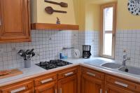 a kitchen with a stove and a sink at S&#39;Harzala Jaune in Bergheim
