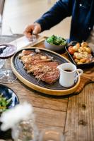 ein Tisch mit einem Teller Essen und einer Tasse Kaffee in der Unterkunft Le Manoir des Impressionnistes - Bord de Mer in Honfleur