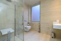 a bathroom with a shower and a toilet and a sink at Saint Georges Hotel &amp; Spa in Chalon-sur-Saône