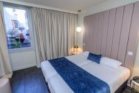 a hotel room with a bed and a window at Saint Georges Hotel &amp; Spa in Chalon-sur-Saône