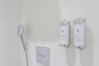 a bathroom with two shampoo bottles on a wall at Saint Georges Hotel &amp; Spa in Chalon-sur-Saône