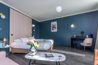 a hotel room with a bed and a table with flowers at Saint Georges Hotel &amp; Spa in Chalon-sur-Saône