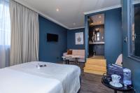 a hotel room with a bed and blue walls at Saint Georges Hotel &amp; Spa in Chalon-sur-Saône
