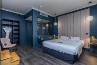 a bedroom with a large bed and blue walls at Saint Georges Hotel &amp; Spa in Chalon-sur-Saône
