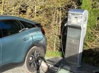 a charging station next to a car with a charging meter at Vignoble Château Piéguë - winery in Rochefort-sur-Loire