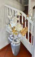 a vase filled with white flowers in a staircase at Villa Paradis in Le François