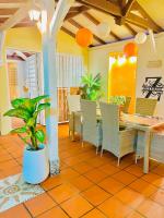 a dining room with a table and chairs at Villa Paradis in Le François