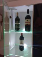 a refrigerator with three bottles of wine in it at Twins Apartments in Čačak
