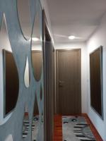 a room with a hallway with a mirror and a door at Twins Apartments in Čačak
