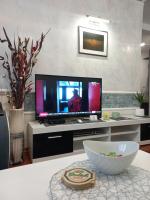 a living room with a television and a bowl on a table at Twins Apartments in Čačak