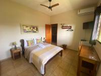 a bedroom with a bed and a ceiling fan at Chico de Sá Pousada in Pirenópolis