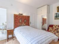 a bedroom with a bed with a red and white blanket at Apartment Le Chalet by Interhome in Cabourg